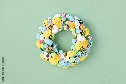 Canvas Print Handmade diy home interior decoration wreath with colorful easter eggs over gree