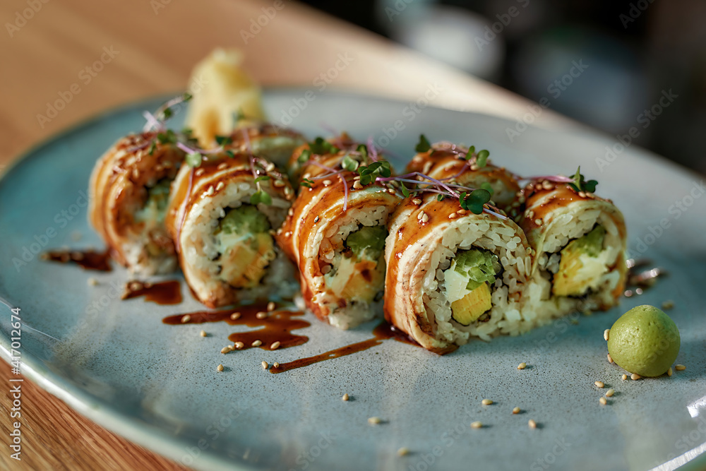 Delicious fresh sushi roll set with unagi and sesame decorated and served on a plate Delicious fresh sushi roll set with unagi and sesame decorated and served on a plate