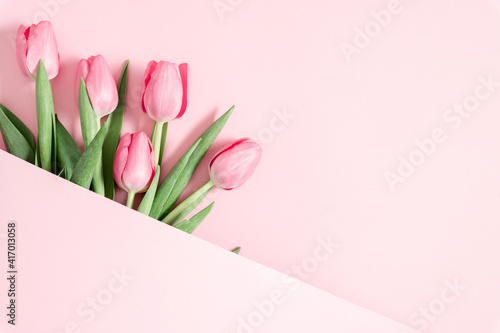 Beautiful pink tulips on pastel pink background. Concept Women's Day, March 8. 8th march. Flat lay, top view, copy space #417013058