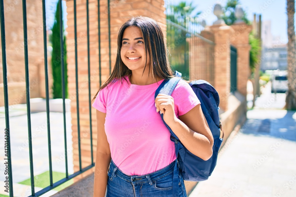Young latin student girl smiling happy at university campus