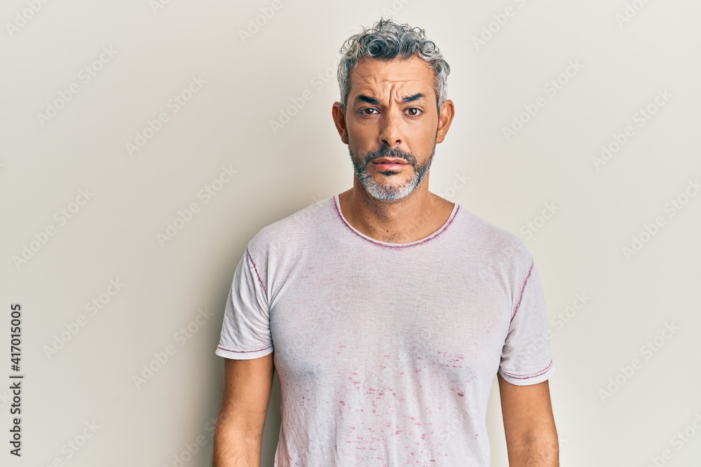 Middle age grey-haired man wearing casual clothes depressed and worry for distress, crying angry and afraid. sad expression. Middle age grey-haired man wearing casual clothes depressed and worry for distress, crying angry and afraid. sad expression.
