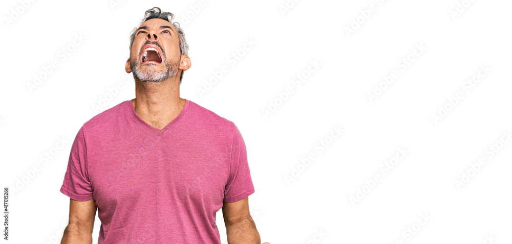 Middle age grey-haired man wearing casual clothes angry and mad screaming frustrated and furious, shouting with anger. rage and aggressive concept. Middle age grey-haired man wearing casual clothes angry and mad screaming frustrated and furious, shouting with anger. rage and aggressive concept.