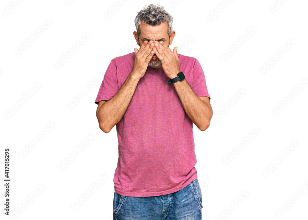 Middle age grey-haired man wearing casual clothes rubbing eyes for fatigue and headache, sleepy and tired expression. vision problem Middle age grey-haired man wearing casual clothes rubbing eyes for fatigue and headache, sleepy and tired expression. vision problem