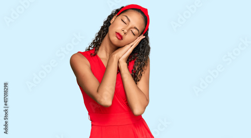 Young african american girl wearing elegant and sexy look sleeping tired dreaming and posing with hands together while smiling with closed eyes. © Krakenimages.com
