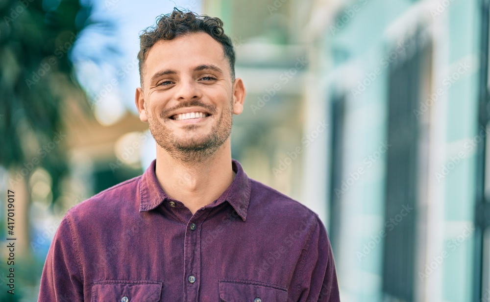 Young hispanic man smiling happy standing at the city. Young hispanic man smiling happy standing at the city.