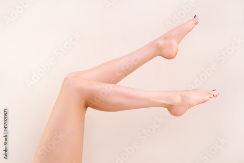 Beautiful long female legs with smooth skin after depilation