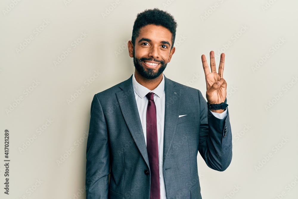 Handsome hispanic man with beard wearing business suit and tie showing and pointing up with fingers number three while smiling confident and happy. Handsome hispanic man with beard wearing business suit and tie showing and pointing up with fingers number three while smiling confident and happy.