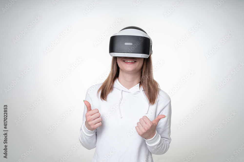 Portrait of a woman, using VR headset and showing thumbs up Portrait of a woman, using VR headset and showing thumbs up
