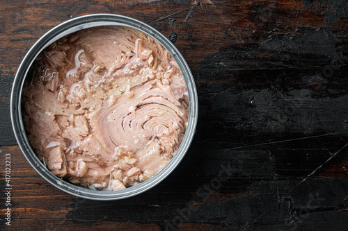 Canned soy free albacore white meat tuna, in tin can, on old dark  wooden table background., top view flat lay photo