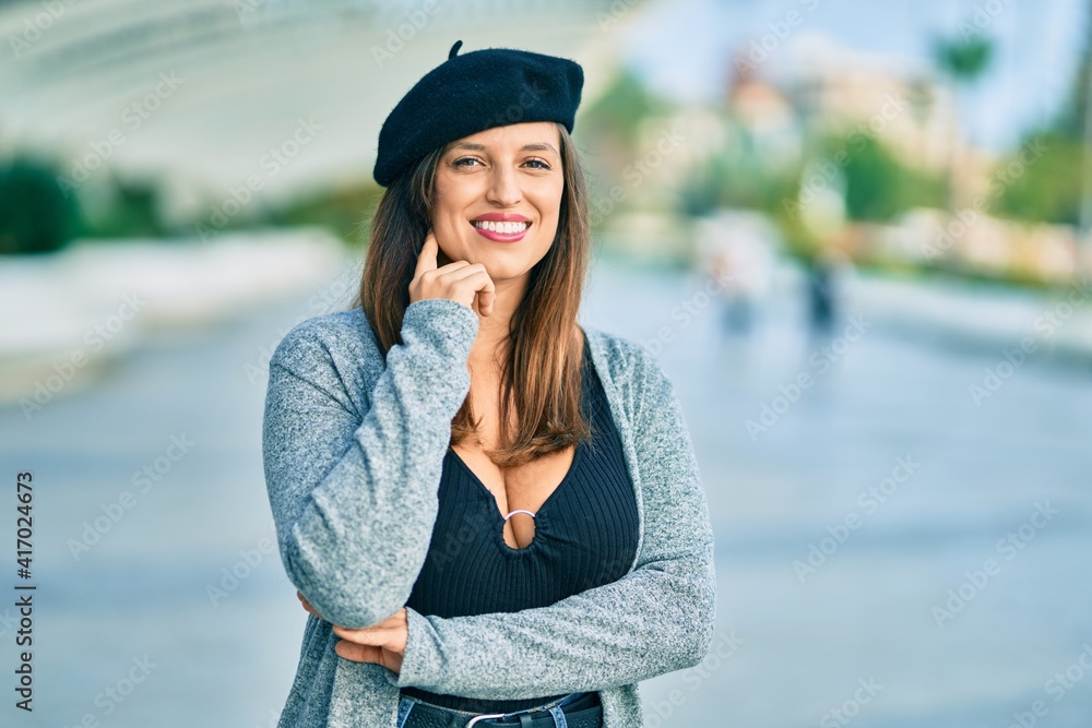 Young latin woman wearing french style standing at the city.