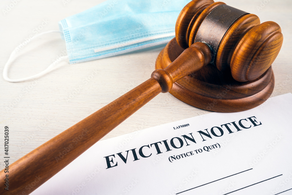 Eviction notice, notice to quit document with facial mask and gavel during covid-19. Eviction notice, notice to quit document with facial mask and gavel during covid-19.