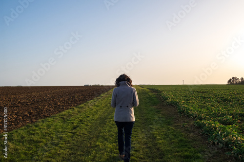 Girl with a coat between two field at dawn © Gnac49