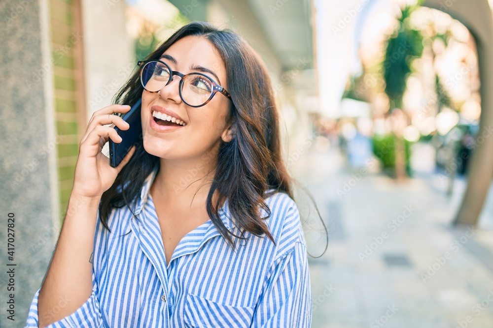 Young hispanic businesswoman smiling happy talking on the smartphone at the city. Young hispanic businesswoman smiling happy talking on the smartphone at the city.