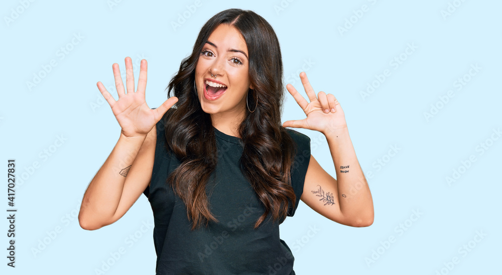 Beautiful brunette young woman wearing black shirt showing and pointing up with fingers number eight while smiling confident and happy. Beautiful brunette young woman wearing black shirt showing and pointing up with fingers number eight while smiling confident and happy.