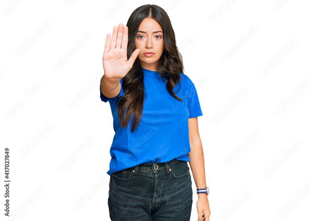 Beautiful brunette young woman wearing casual clothes doing stop sing with palm of the hand. warning expression with negative and serious gesture on the face. Beautiful brunette young woman wearing casual clothes doing stop sing with palm of the hand. warning expression with negative and serious gesture on the face.
