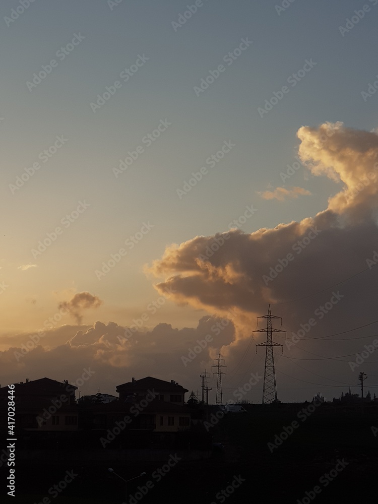clouds and house silhouettes at sunset