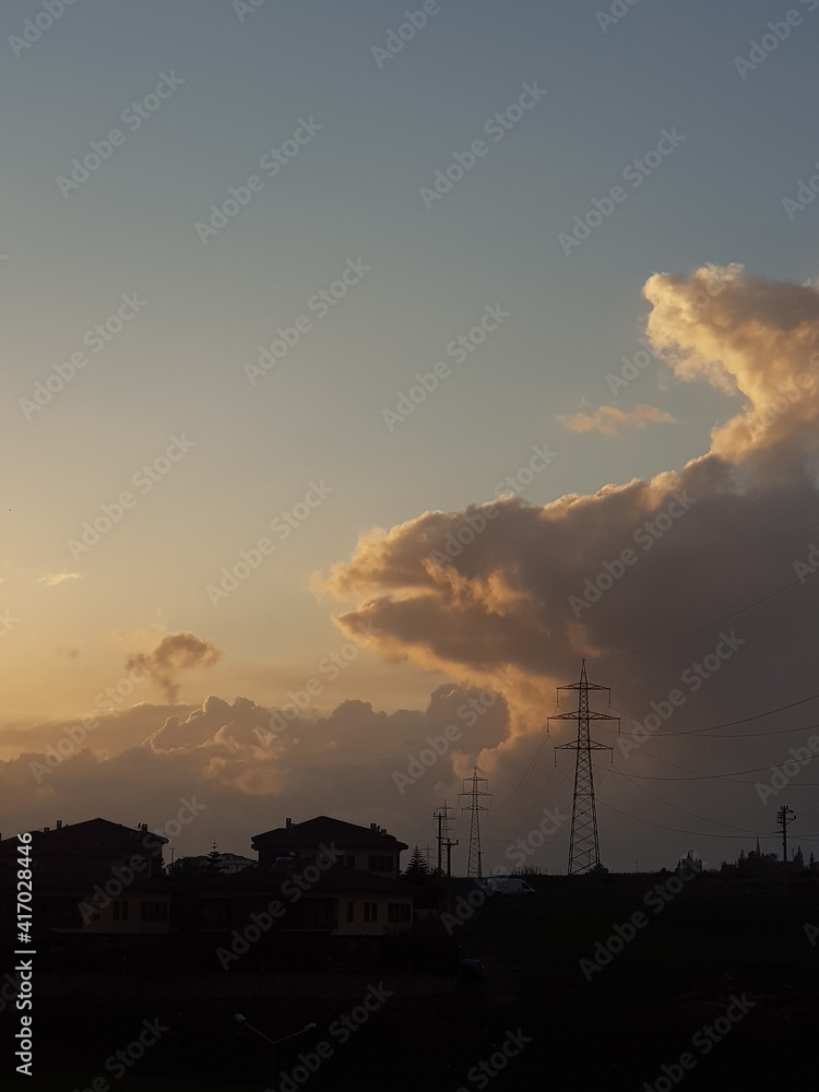 clouds and house silhouettes at sunset clouds and house silhouettes at sunset