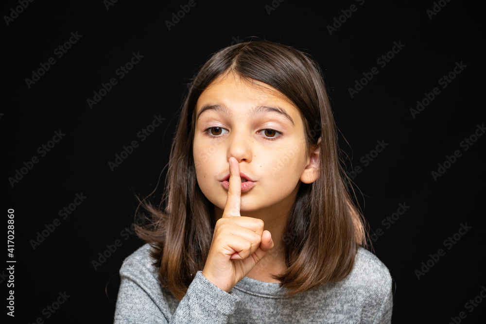 Girl, schoolgirl meditates, expresses emotions, close-up on a black background Girl, schoolgirl meditates, expresses emotions, close-up on a black background