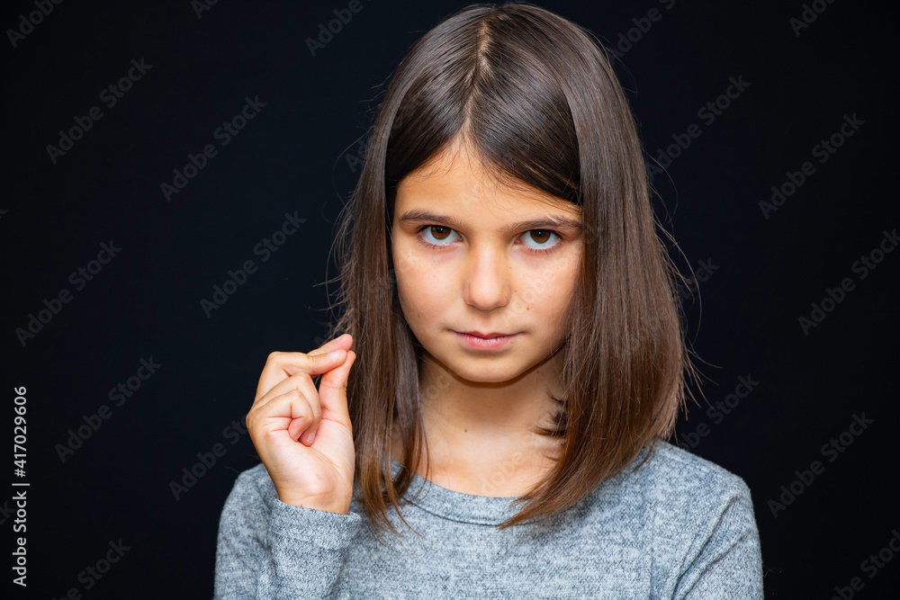 Girl, schoolgirl meditates, expresses emotions, close-up on a black background Girl, schoolgirl meditates, expresses emotions, close-up on a black background