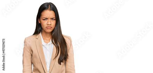 Obraz na plátně Beautiful hispanic woman wearing business jacket skeptic and nervous, frowning upset because of problem