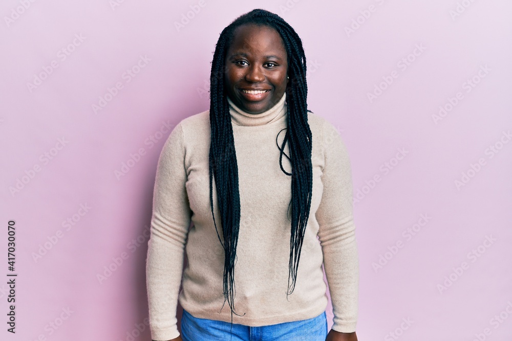 Young black woman with braids wearing casual winter sweater with a happy and cool smile on face. lucky person. Young black woman with braids wearing casual winter sweater with a happy and cool smile on face. lucky person.