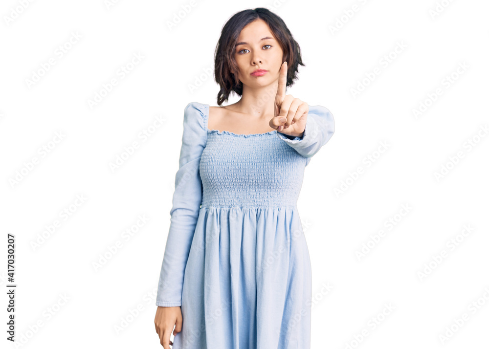 Young beautiful girl wearing casual clothes pointing with finger up and angry expression, showing no gesture Young beautiful girl wearing casual clothes pointing with finger up and angry expression, showing no gesture