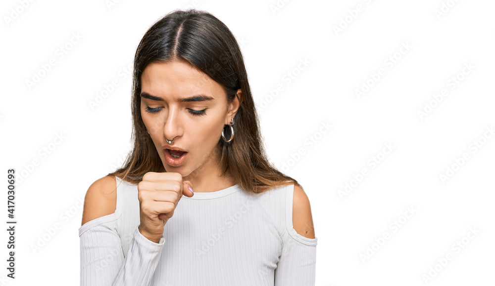 Young hispanic woman wearing casual clothes feeling unwell and coughing as symptom for cold or bronchitis. health care concept. Young hispanic woman wearing casual clothes feeling unwell and coughing as symptom for cold or bronchitis. health care concept.