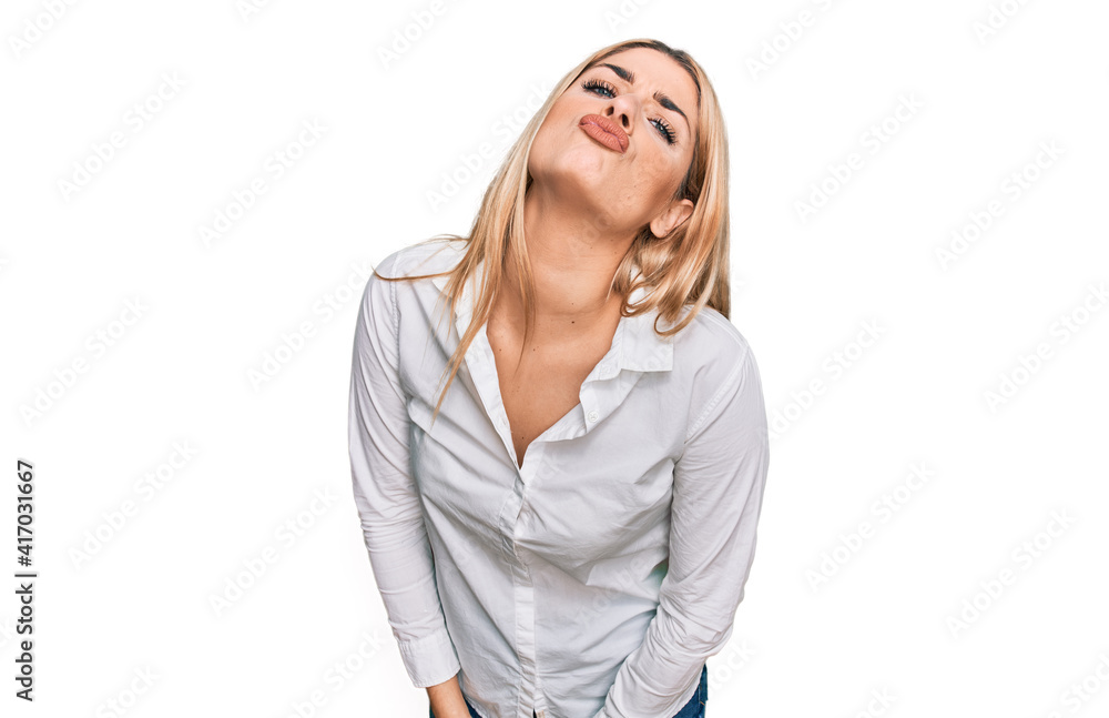 Young caucasian woman wearing casual clothes looking at the camera blowing a kiss on air being lovely and sexy. love expression. Young caucasian woman wearing casual clothes looking at the camera blowing a kiss on air being lovely and sexy. love expression.