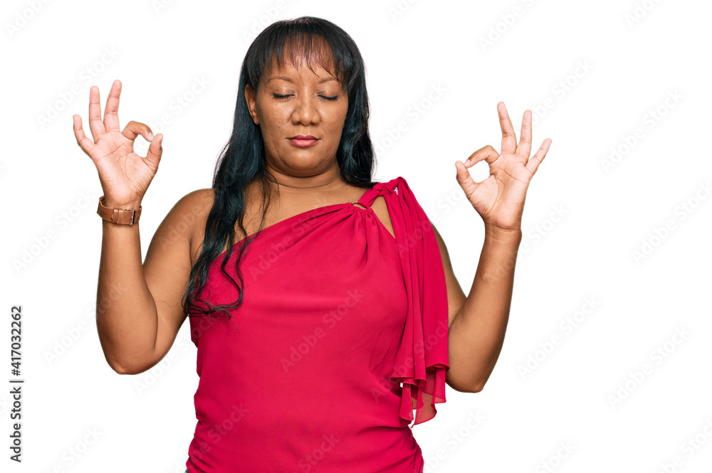 Hispanic middle age woman wearing casual clothes relax and smiling with eyes closed doing meditation gesture with fingers. yoga concept. Hispanic middle age woman wearing casual clothes relax and smiling with eyes closed doing meditation gesture with fingers. yoga concept.