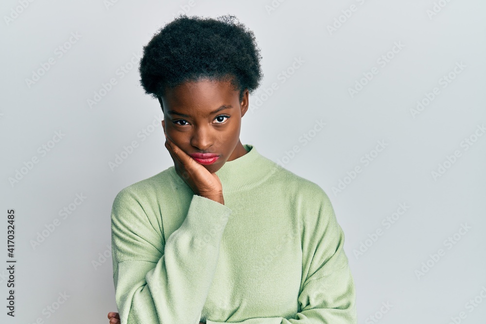 Young african american girl wearing casual clothes thinking looking tired and bored with depression problems with crossed arms. Young african american girl wearing casual clothes thinking looking tired and bored with depression problems with crossed arms.