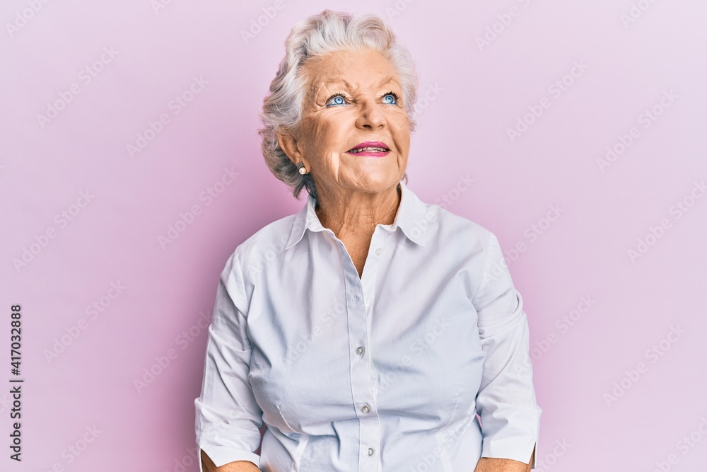 Senior grey-haired woman wearing casual clothes looking to side, relax profile pose with natural face and confident smile. Senior grey-haired woman wearing casual clothes looking to side, relax profile pose with natural face and confident smile.