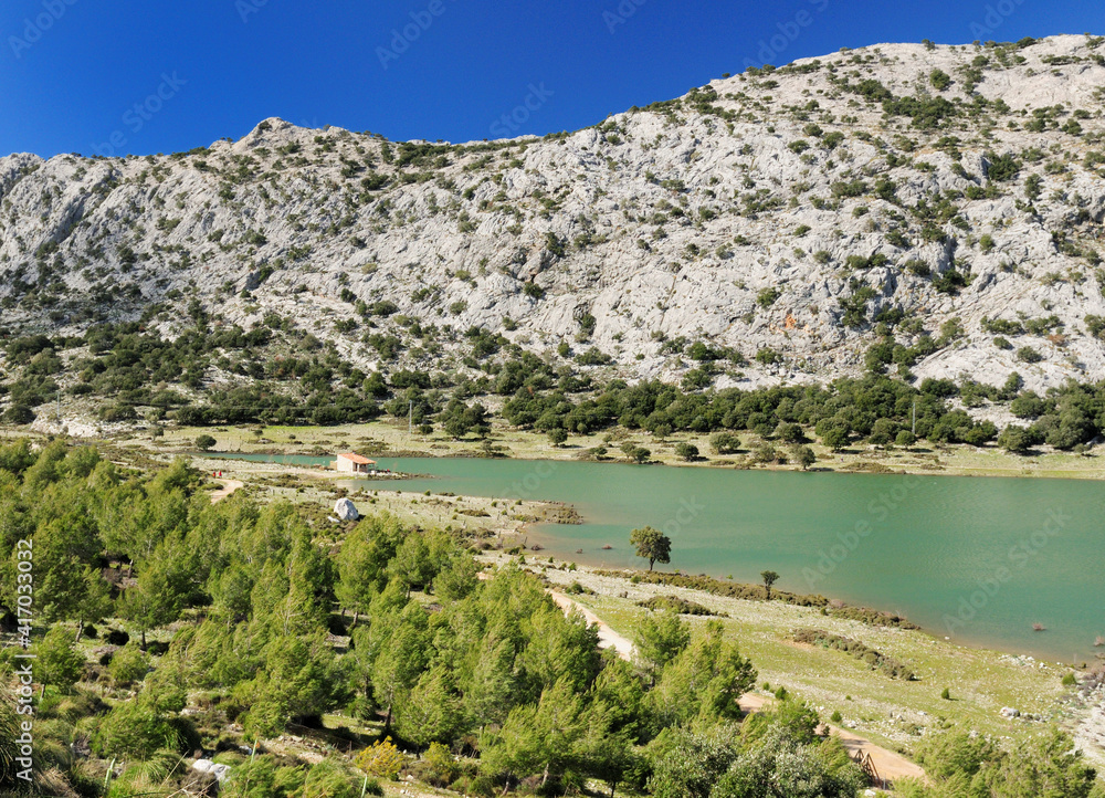 View To Barren Landscape At Lake Cuber In The Tramuntana Mountains On Balearic Island Mallorca On A Sunny Winter Day With A Clear Blue Sky