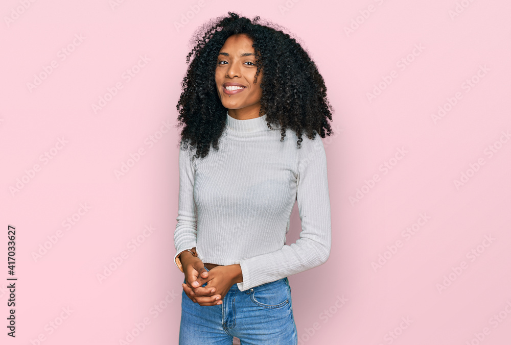 Young african american girl wearing casual clothes with hands together and crossed fingers smiling relaxed and cheerful. success and optimistic Young african american girl wearing casual clothes with hands together and crossed fingers smiling relaxed and cheerful. success and optimistic