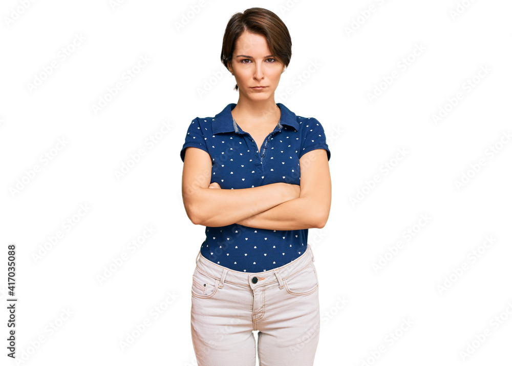 Young brunette woman with short hair wearing casual clothes skeptic and nervous, disapproving expression on face with crossed arms. negative person. Young brunette woman with short hair wearing casual clothes skeptic and nervous, disapproving expression on face with crossed arms. negative person.