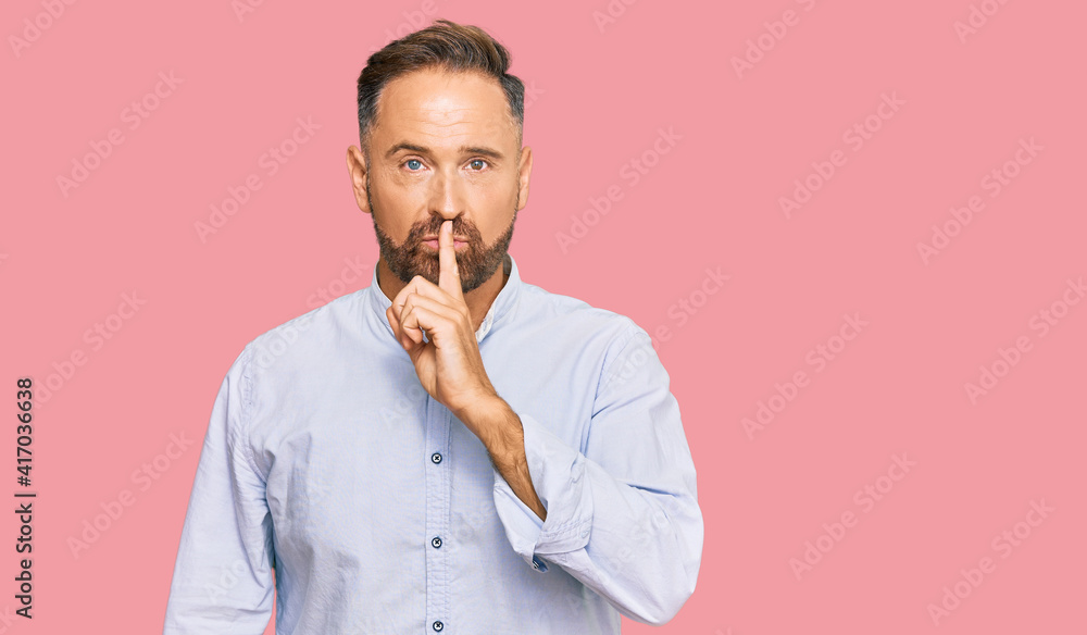 Handsome middle age man wearing business shirt asking to be quiet with finger on lips. silence and secret concept. - obrazy, fototapety, plakaty 