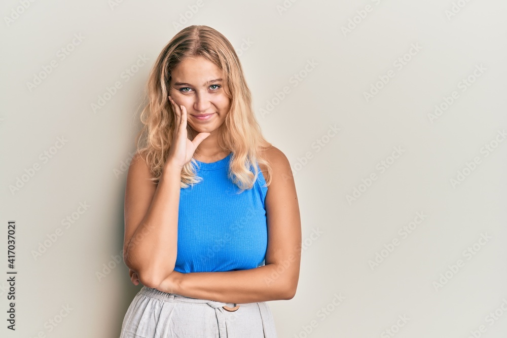 Naklejka premium Young blonde girl wearing casual clothes thinking looking tired and bored with depression problems with crossed arms.
