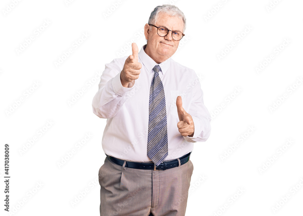 Senior grey-haired man wearing business clothes pointing fingers to camera with happy and funny face. good energy and vibes. Senior grey-haired man wearing business clothes pointing fingers to camera with happy and funny face. good energy and vibes.
