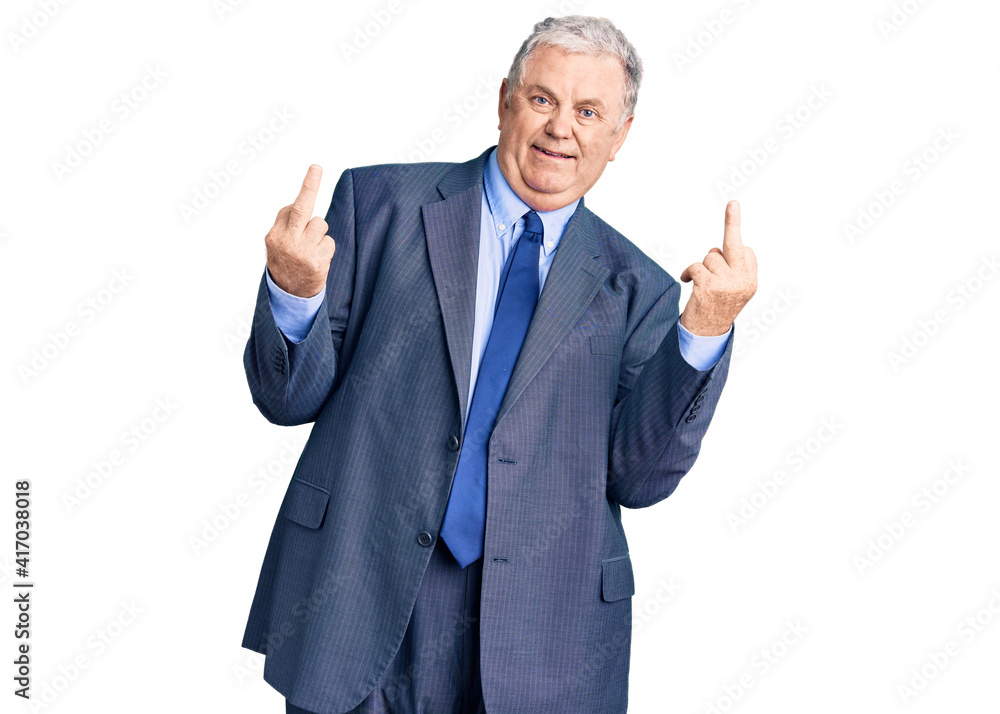 Senior grey-haired man wearing business jacket showing middle finger doing fuck you bad expression, provocation and rude attitude. screaming excited