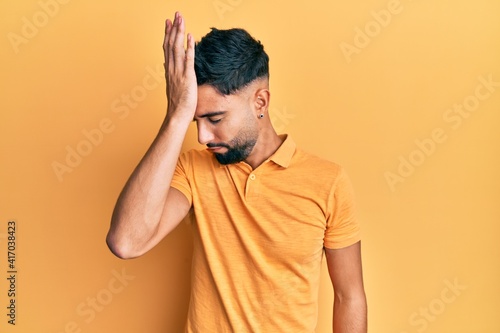 Young man with beard wearing casual clothes surprised with hand on head for mistake, remember error. forgot, bad memory concept. © Krakenimages.com