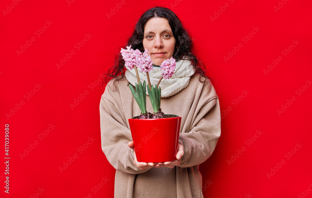 beautiful dressed woman a pot with hyacinth plants on red background beautiful dressed woman a pot with hyacinth plants on red background