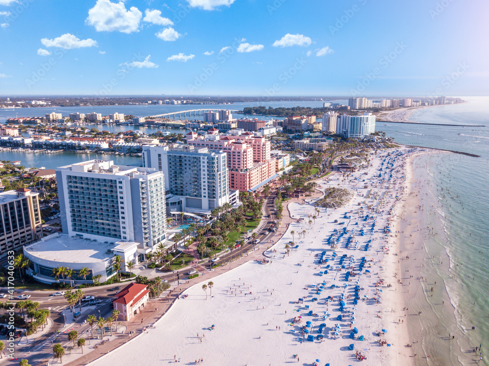 Ocean beach. Spring break or Summer vacations in Florida. Hotels, restaurants and Resorts in US. Blue-turquoise color water. American Coast or shore Gulf of Mexico. Clearwater Beach FL. Aerial view