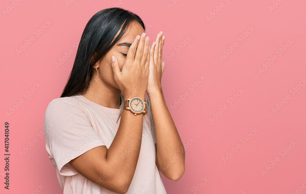 Young asian woman wearing casual clothes with sad expression covering face with hands while crying. depression concept. Young asian woman wearing casual clothes with sad expression covering face with hands while crying. depression concept.