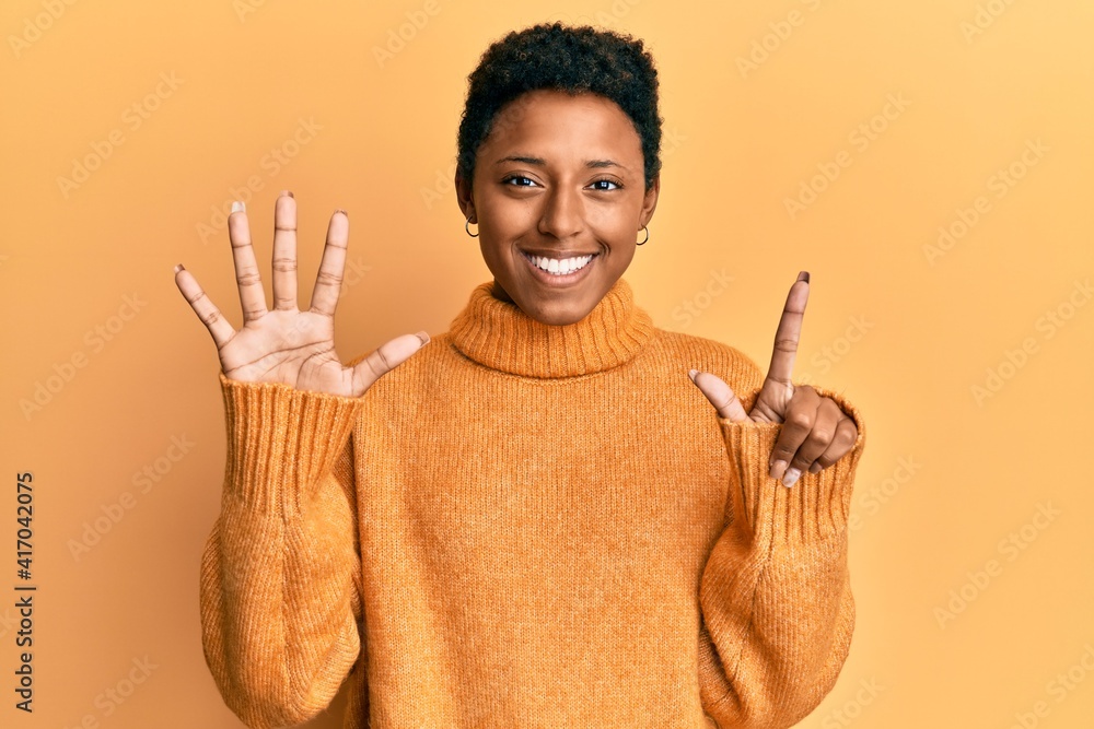 Young african american girl wearing casual clothes showing and pointing up with fingers number seven while smiling confident and happy. Young african american girl wearing casual clothes showing and pointing up with fingers number seven while smiling confident and happy.