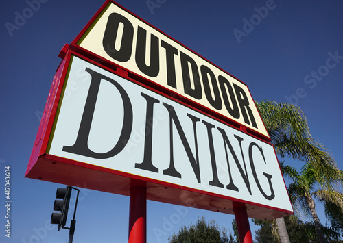 Outdoor dining sign with palm tree