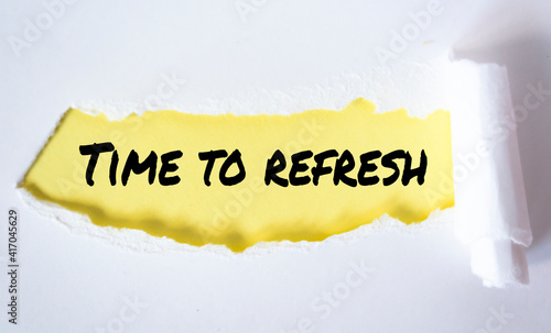 The word time to refresh appearing behind torn paper