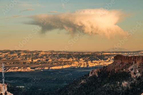 dramatic fleeting huge cumulonimbus clouds with a touch of a rainbow in Bryce Canyon National Park in Utah.