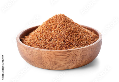 Bowl of sweet coconut sugar on white background