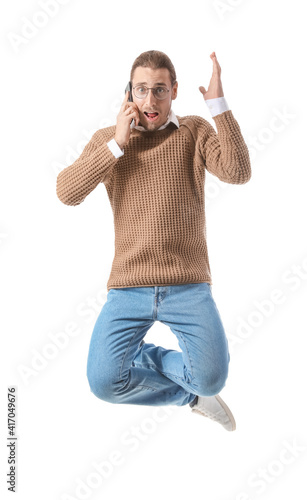 Jumping young man talking b...