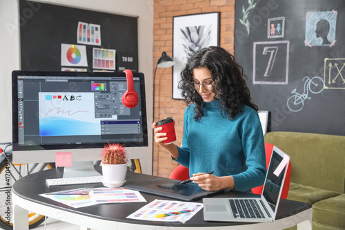 Young female designer working in office