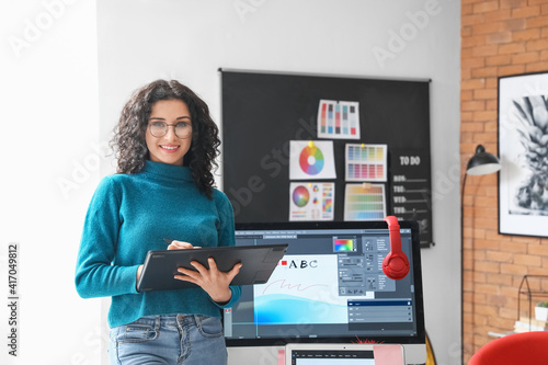 Young female designer working in office photo